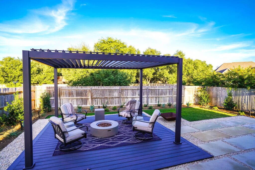 Pergola above a cozy patio lounge in a lush landscaped garden